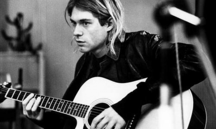 Black and White Photo of Kurt Cobain Holding a Guitar